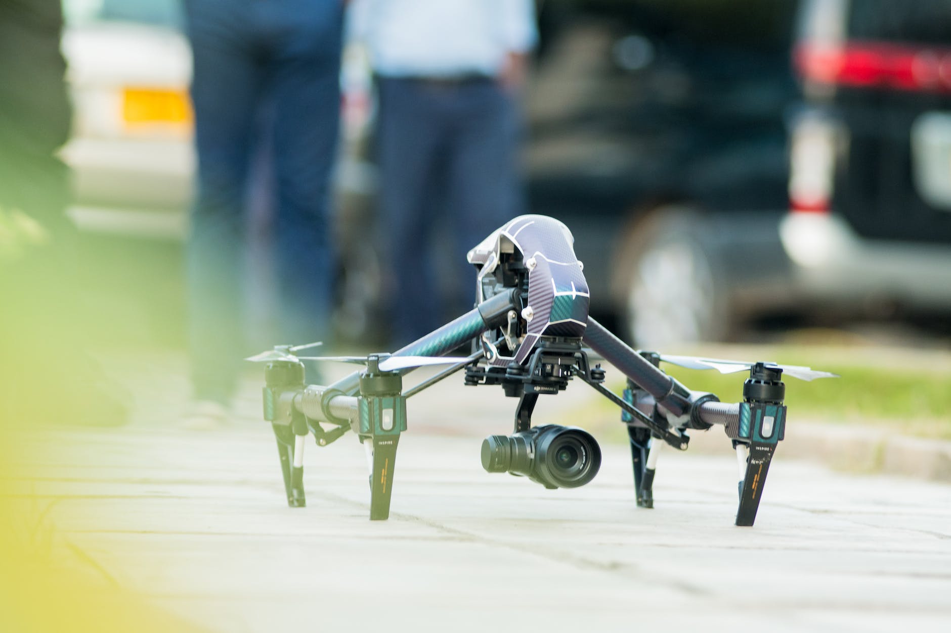 gray and green quadcopter drone on ground
