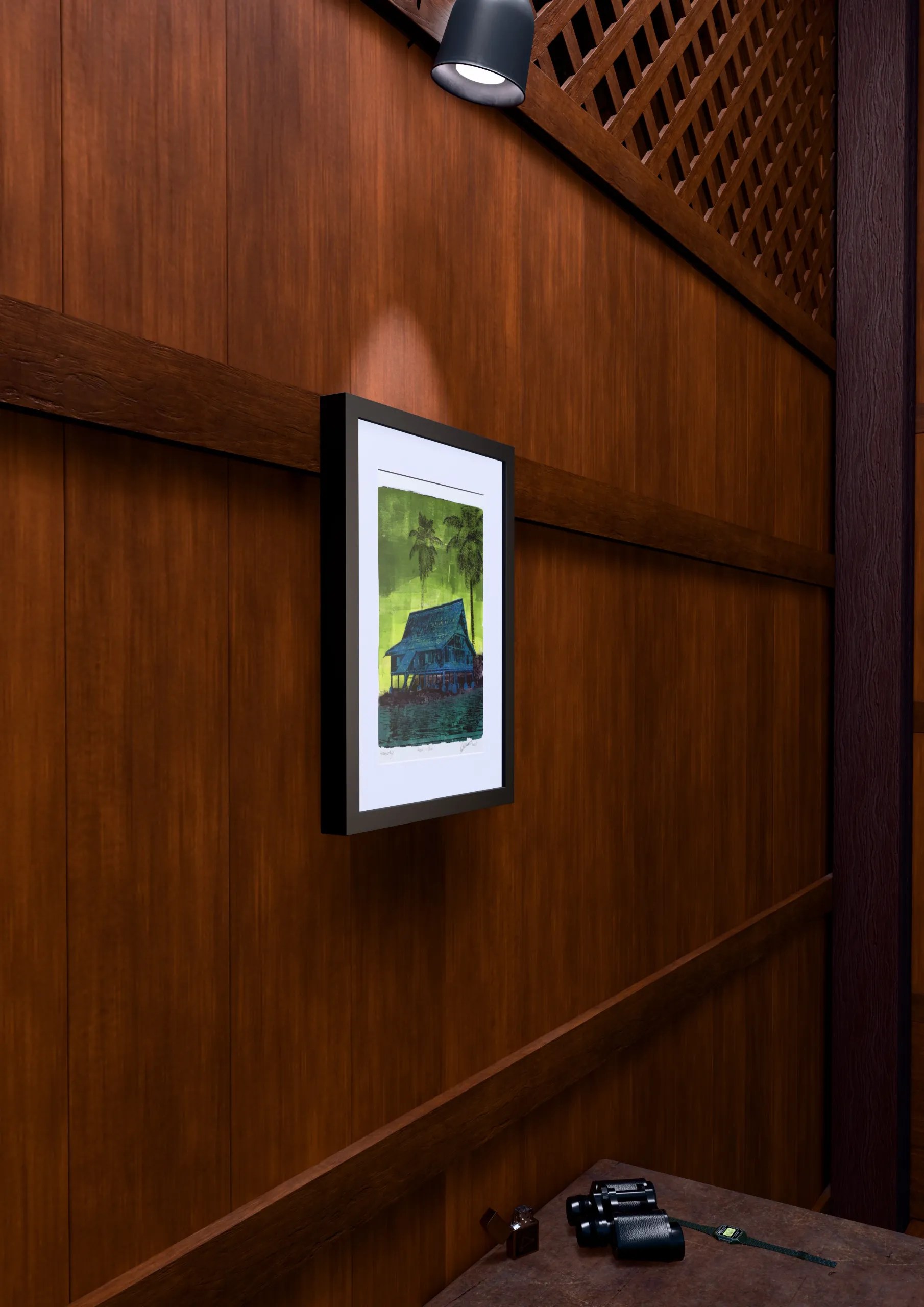 House in Blue, gel plate monotype by Daniel Arendzen, framed on a wooden wall under a spotlight, seen from the side, with binoculars, a watch and a lighter on a table below. The room is a Blender render of the interior of the same traditional Malaysian house shown in the print.