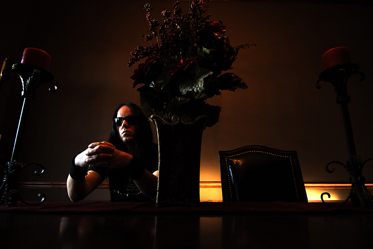 Joey Jordison, batteur du groupe Slipknot, assis derrière une table décorée chez lui à Des Moines. © Daniel Mielniczek.