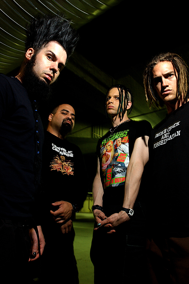 Static-X photographié dans un parking, les quatre membres posent avec intensité sous un éclairage artificiel.