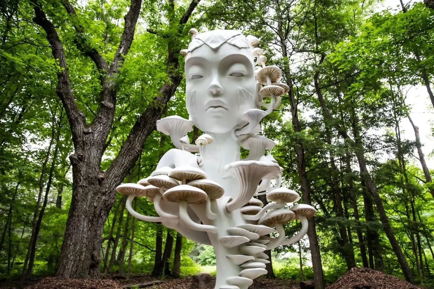 White face with mushrooms spiralling across its chest and head in Mycelia by Daniel Popper at The Morton Arboretum in Lisle, Illinois