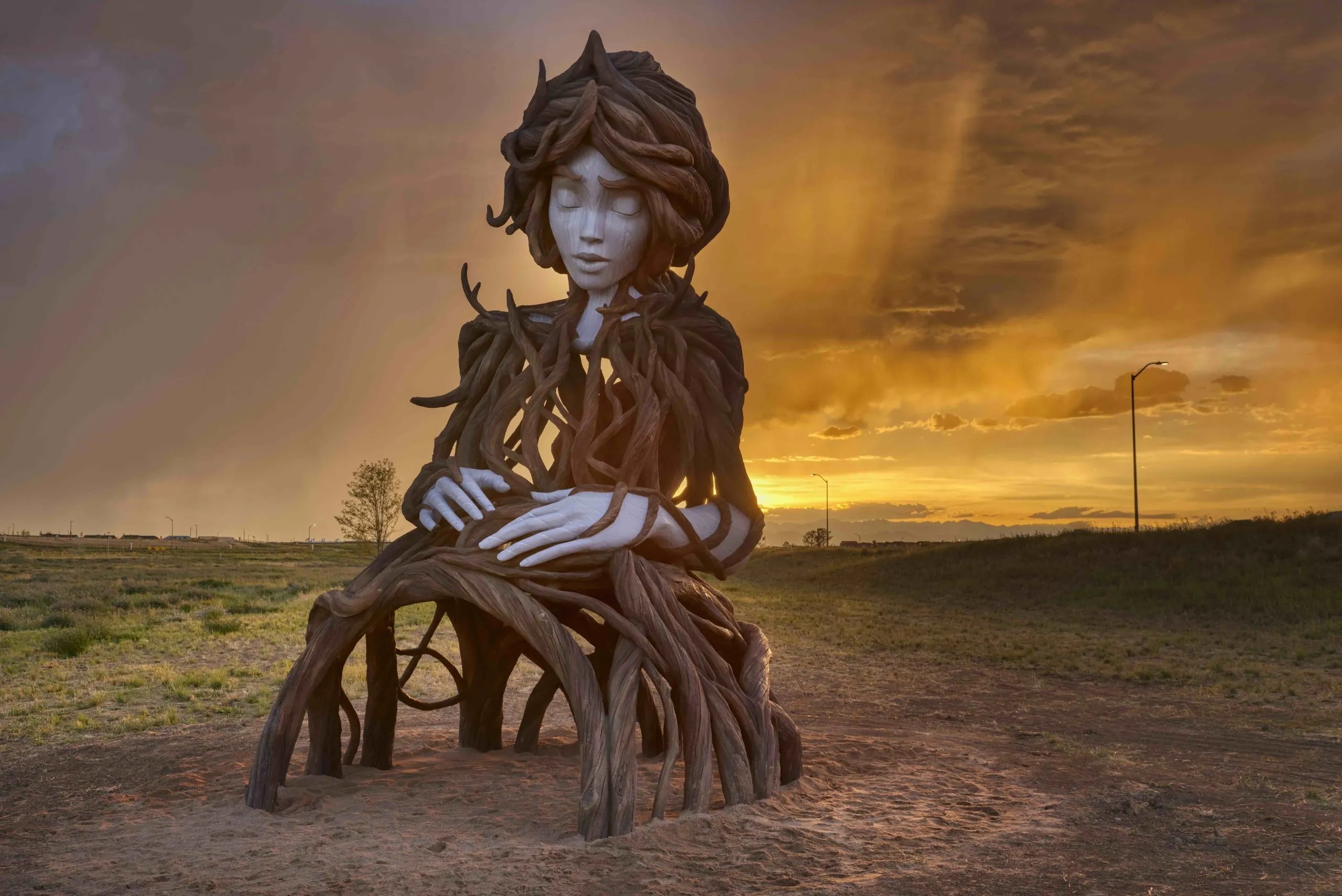 Seated woman formed from intertwined roots in UMI by Daniel Popper at The Aurora Highlands in Aurora, Colorado