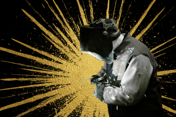 Professional welder in protective gear demonstrating blue collar skilled trade career path