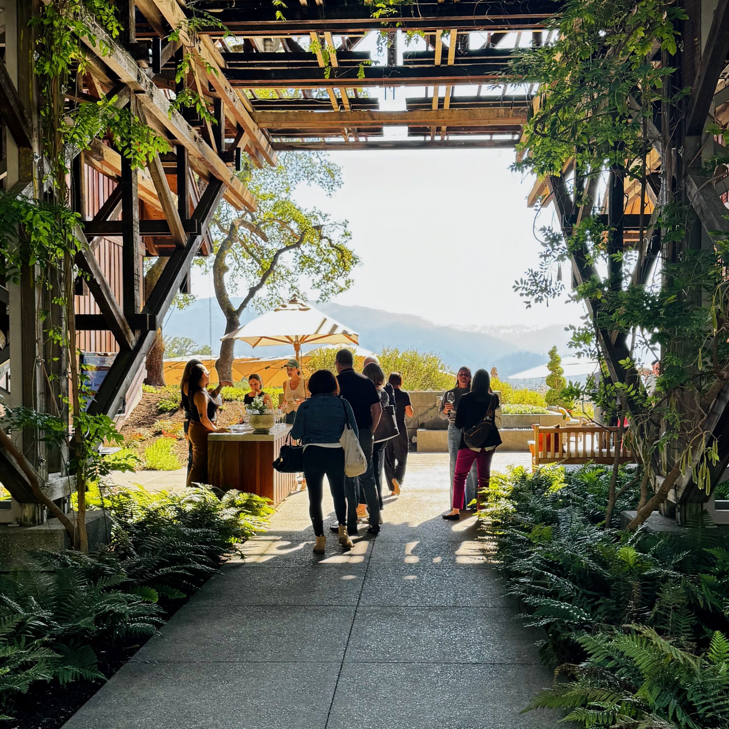 People standing in a winery breezeway.