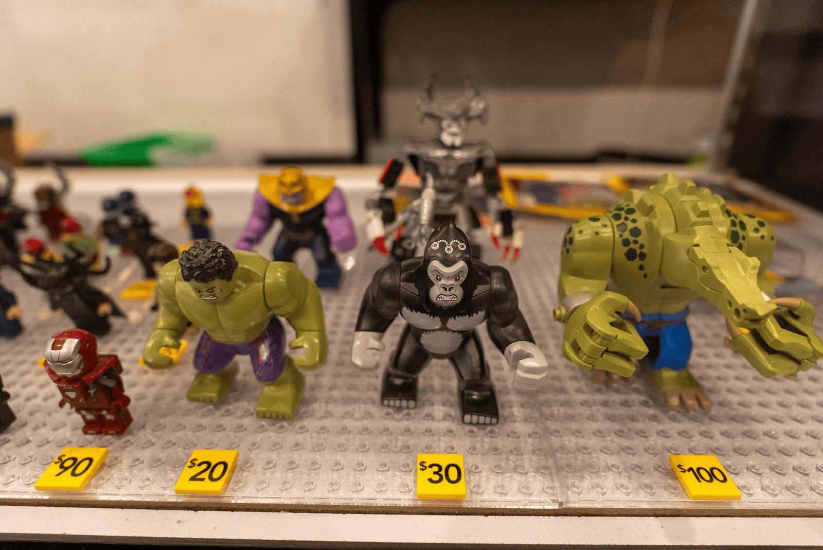 Collectible LEGO character figures arranged behind glass