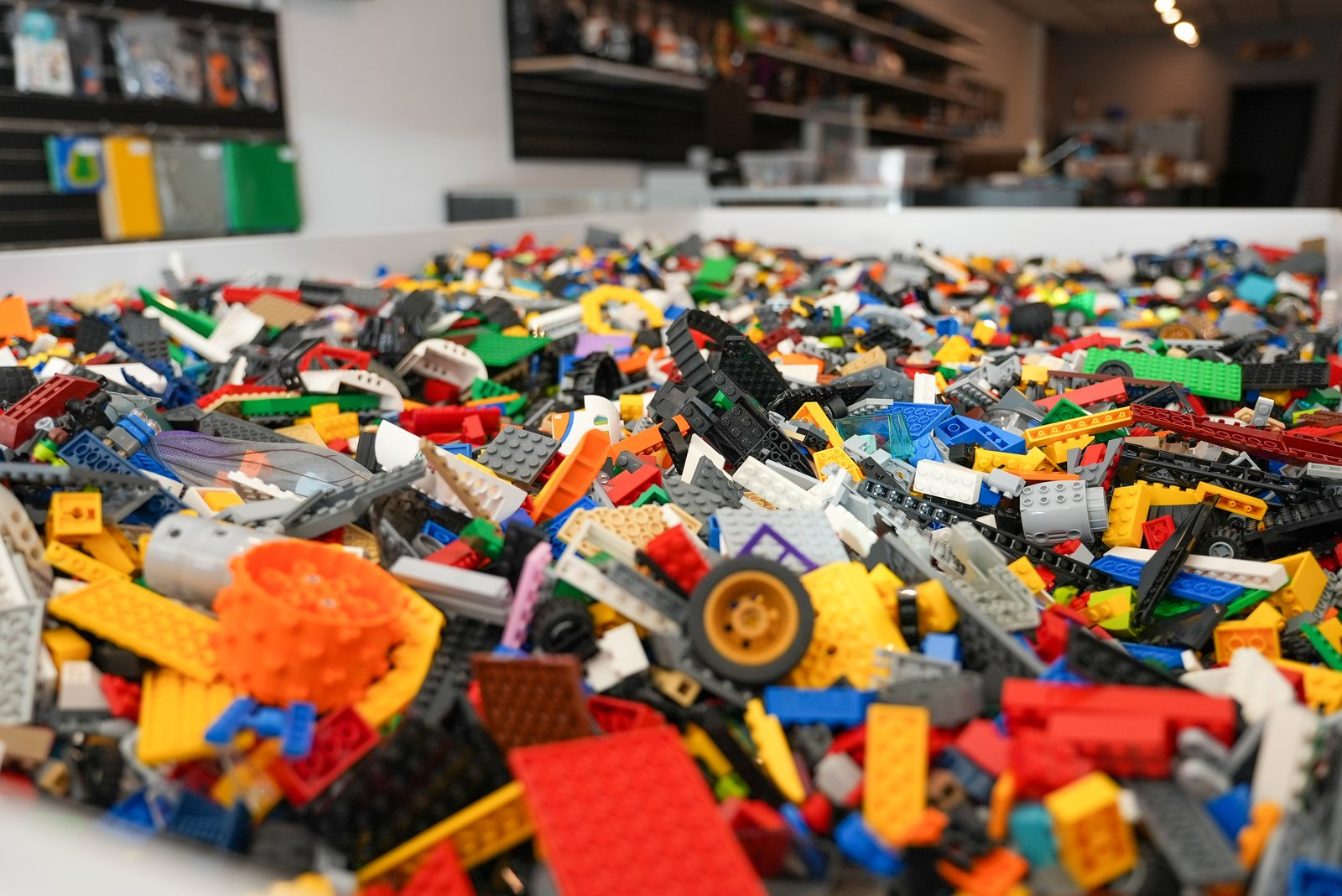 A close view of colorful loose LEGO bricks in a bulk bin