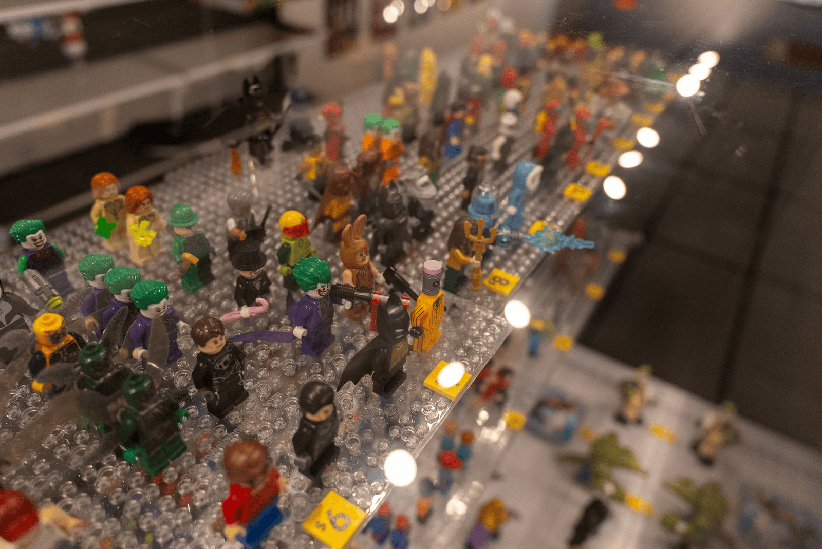 Rows of collectible LEGO minifigures behind glass