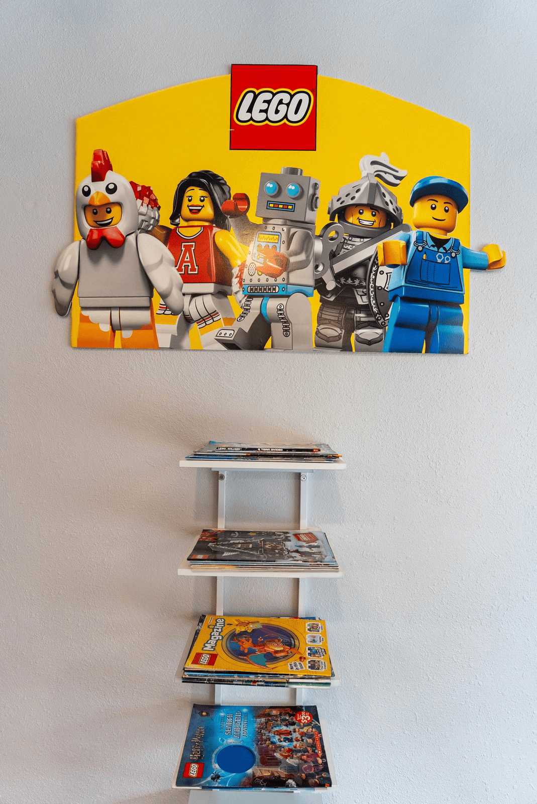 A LEGO minifigure wall sign above a store display