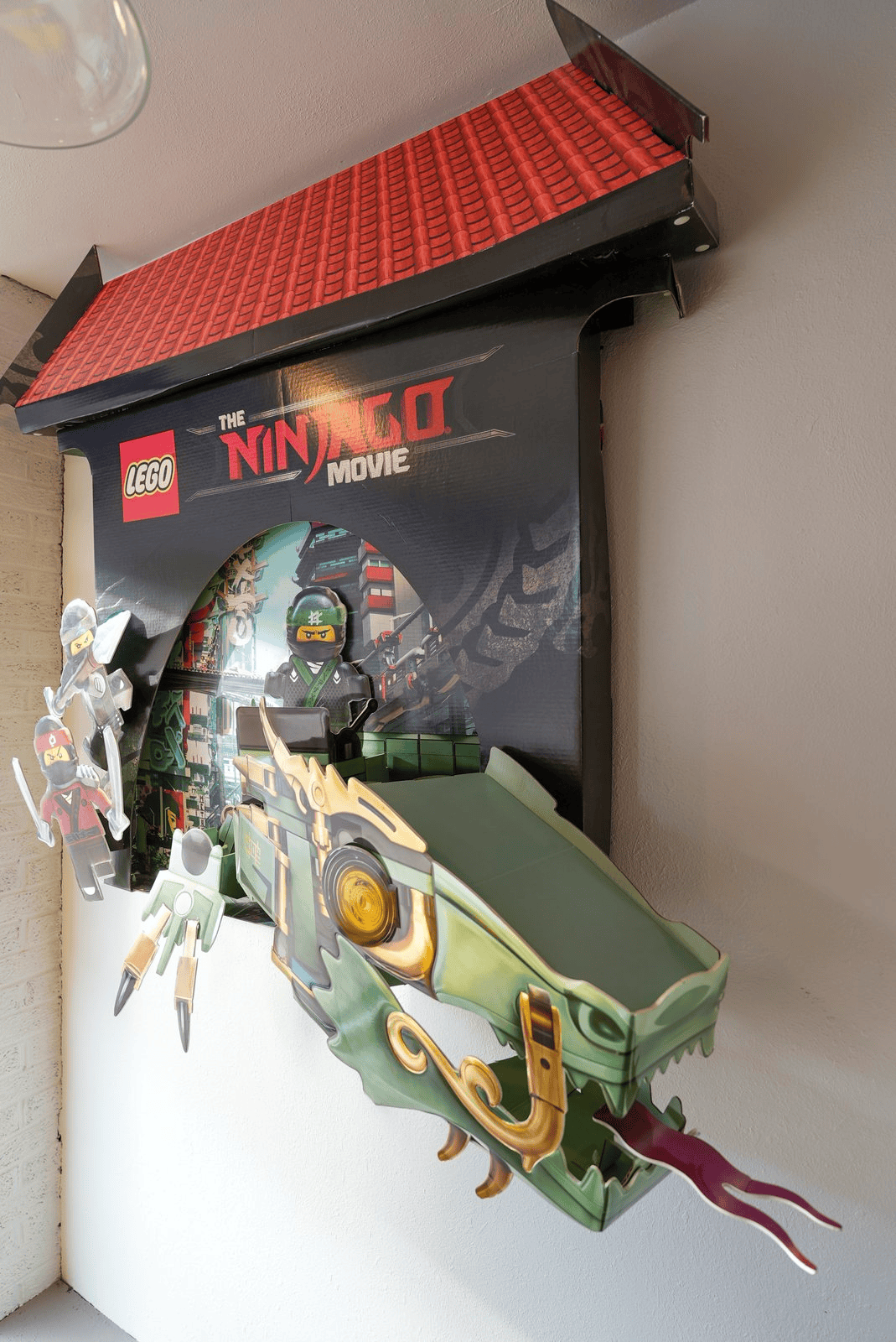 A LEGO Ninjago display mounted on the store wall
