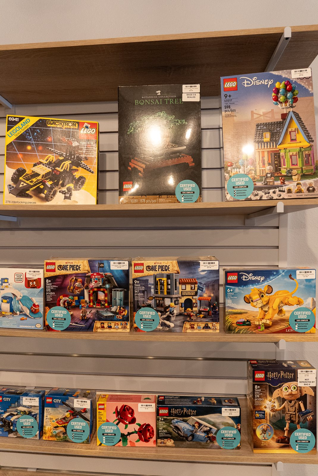 Shelves of boxed and assembled LEGO sets