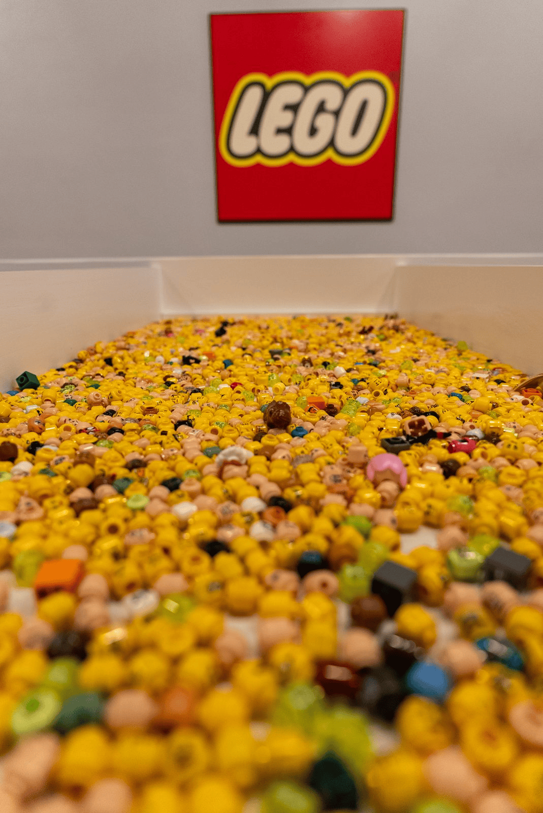 A bulk bin of yellow LEGO bricks inside the store