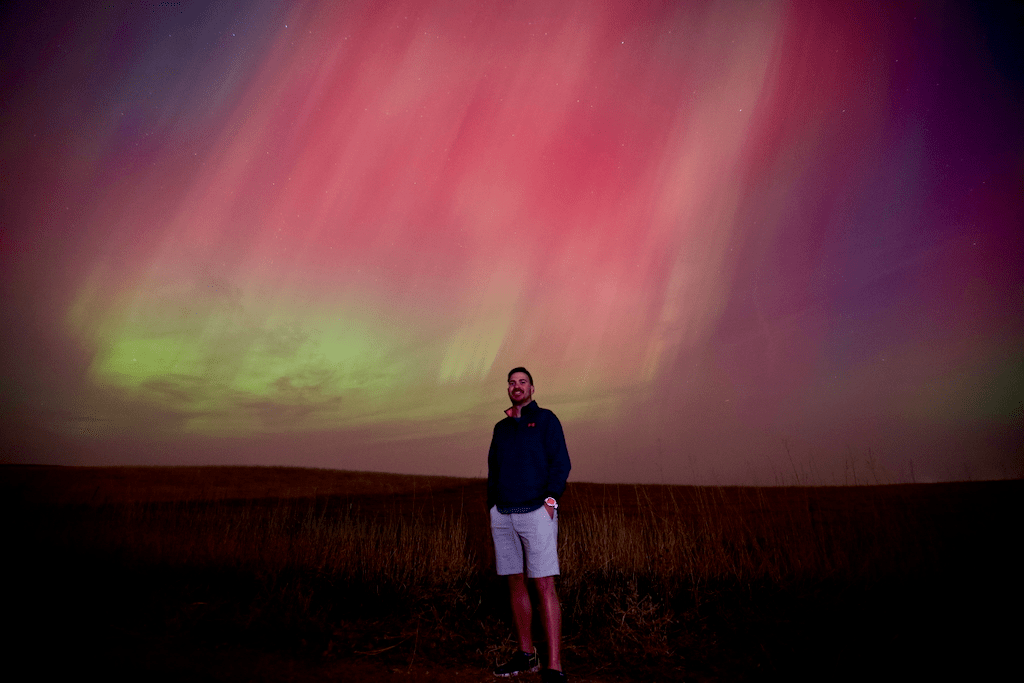 Man standing in front of the northern lights