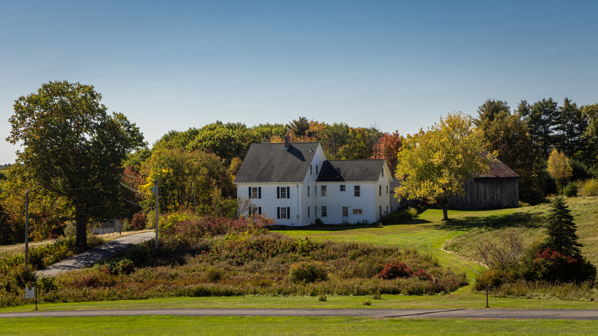 White farmhouse across a green field