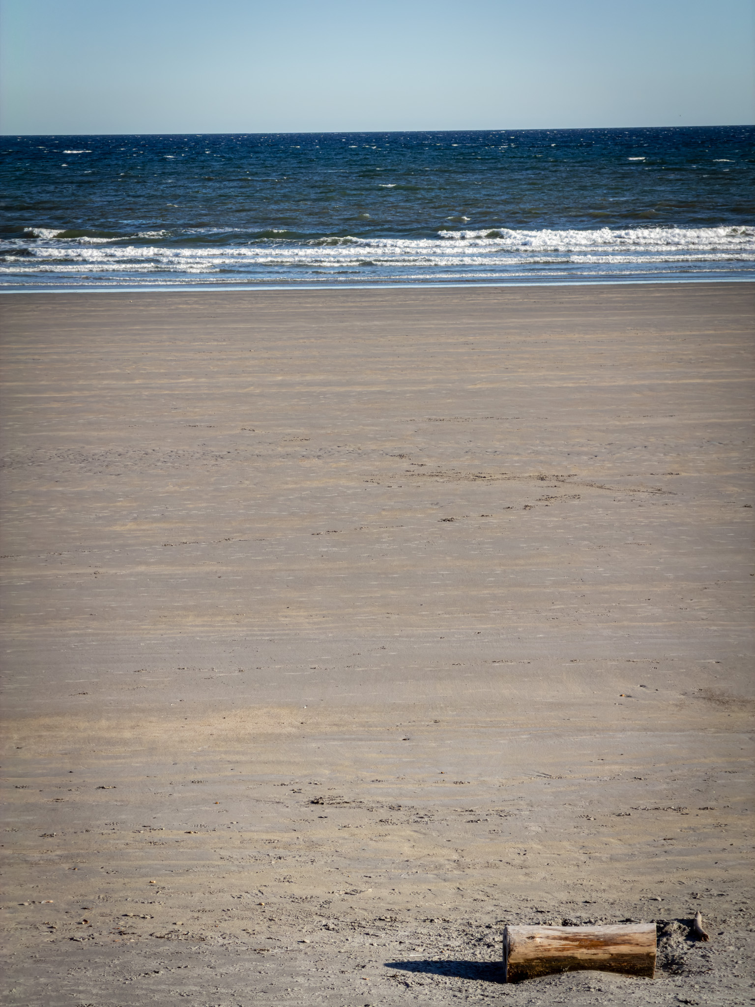 Empty sand and waves at Long Sands Beach