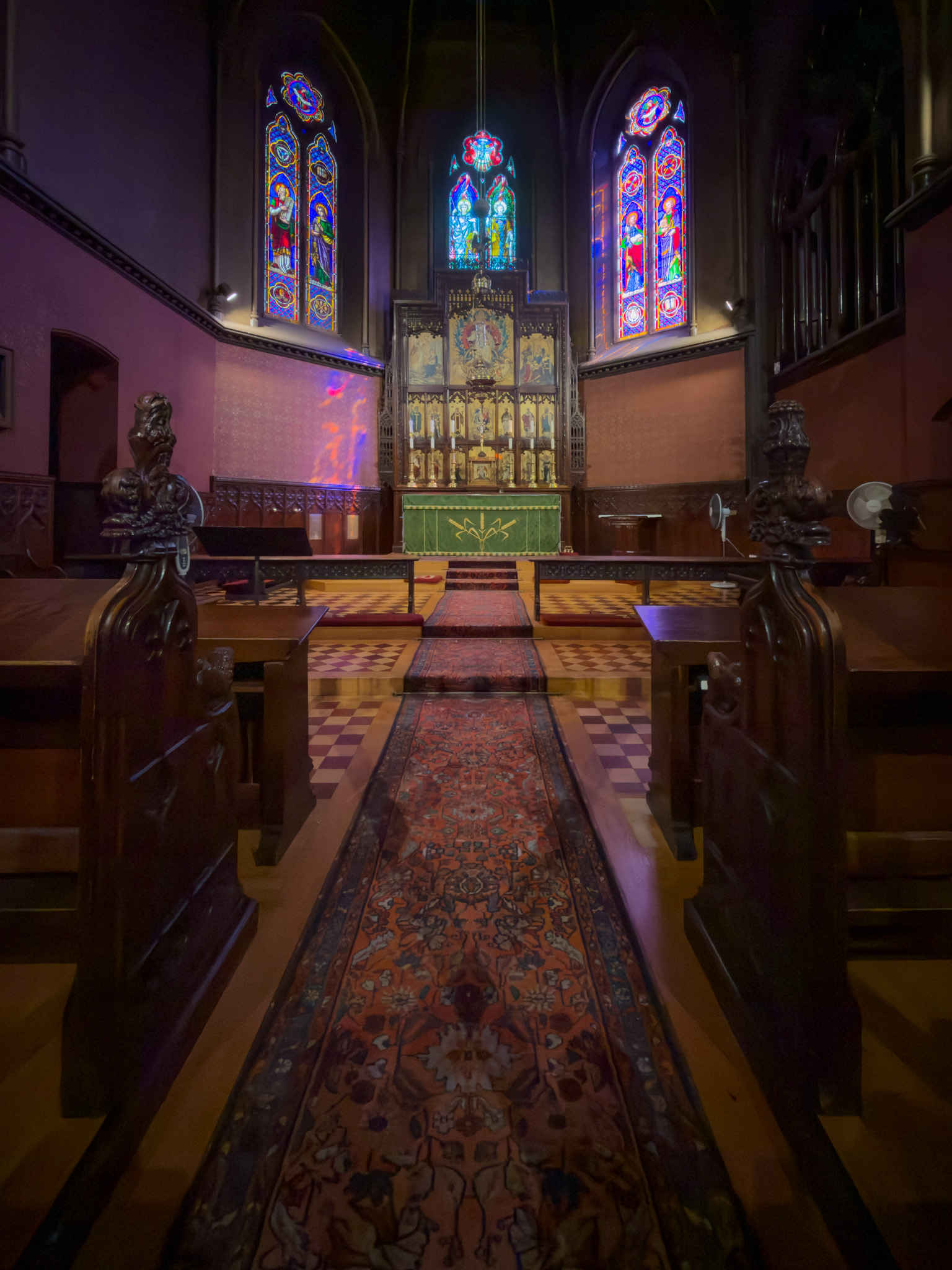 Altar and stained glass windows inside the church