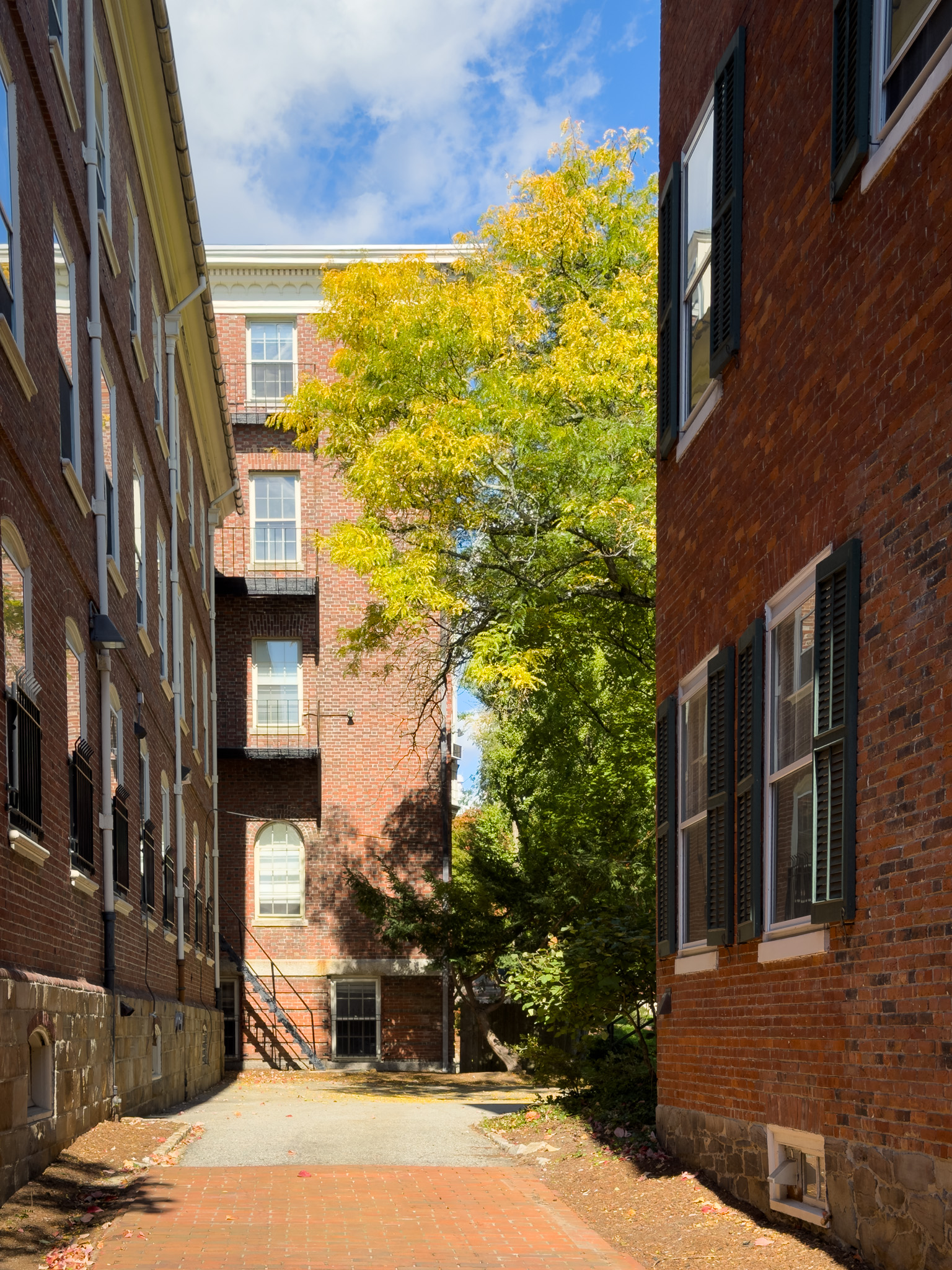 Narrow brick passage between old buildings