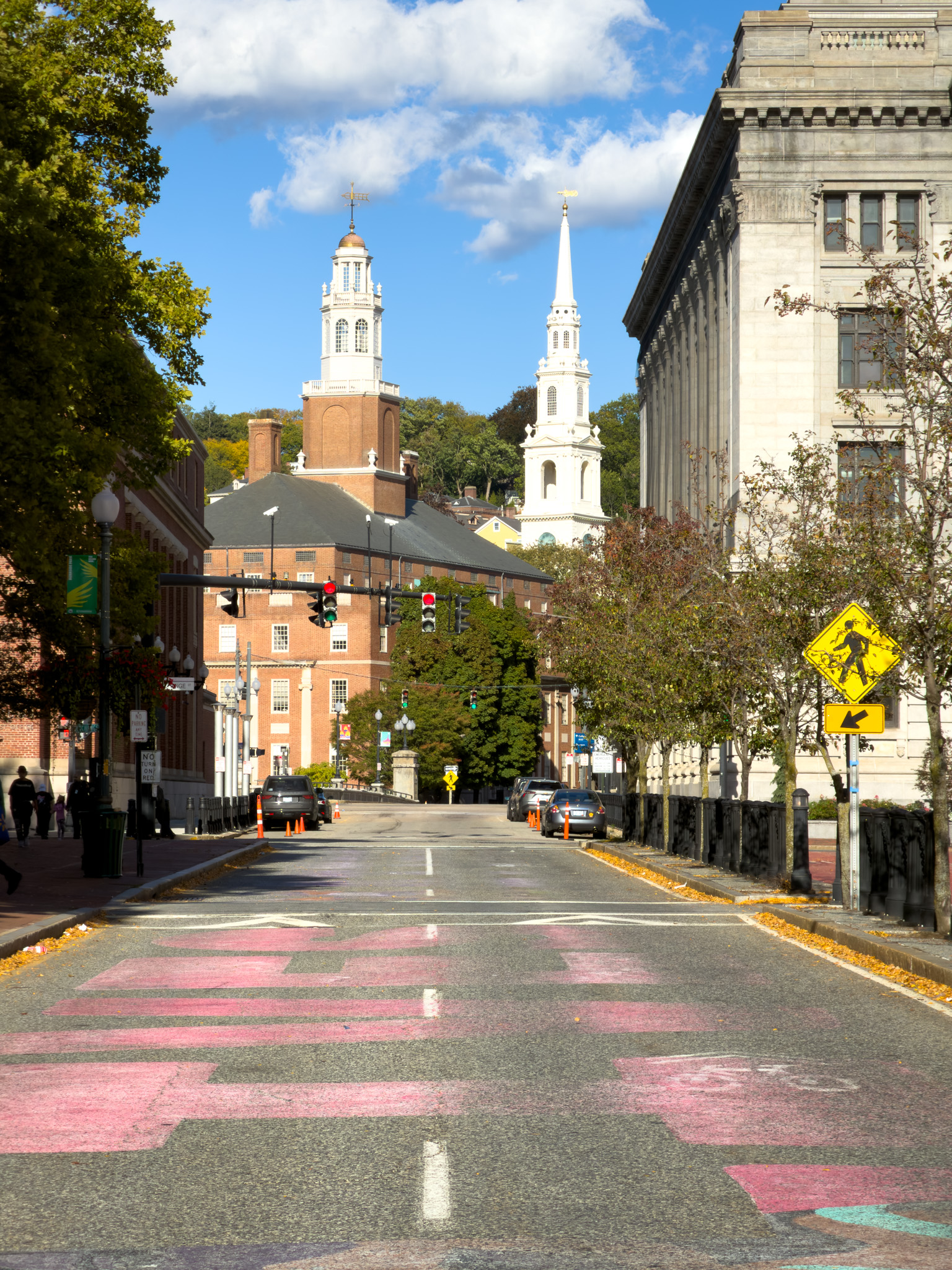 Street climbing toward a white church steeple
