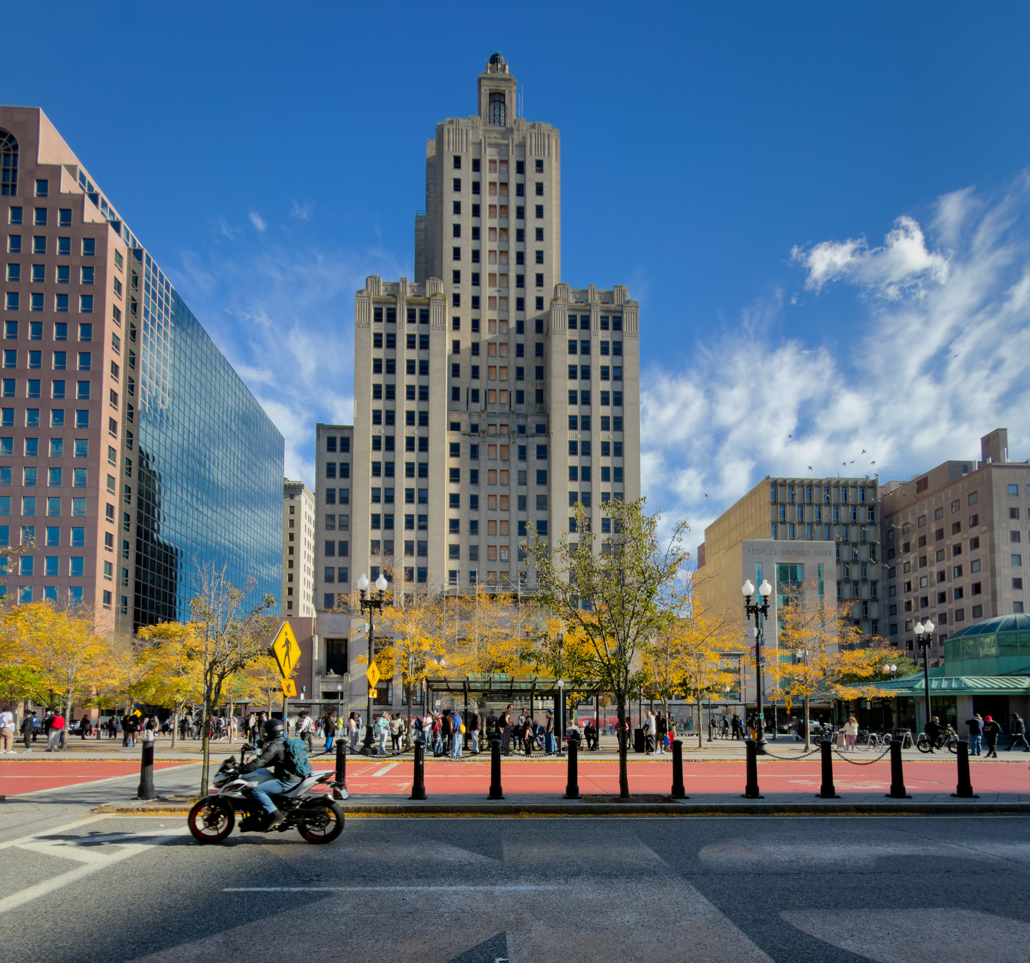 Motorcyclist passing the Art Deco Industrial Trust building
