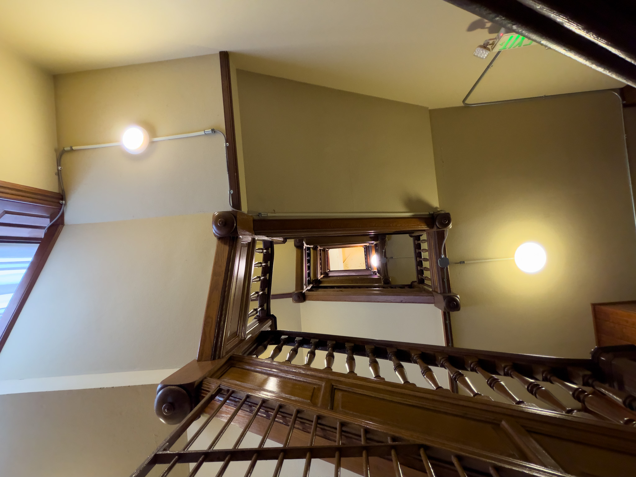 Looking up a curving wooden staircase