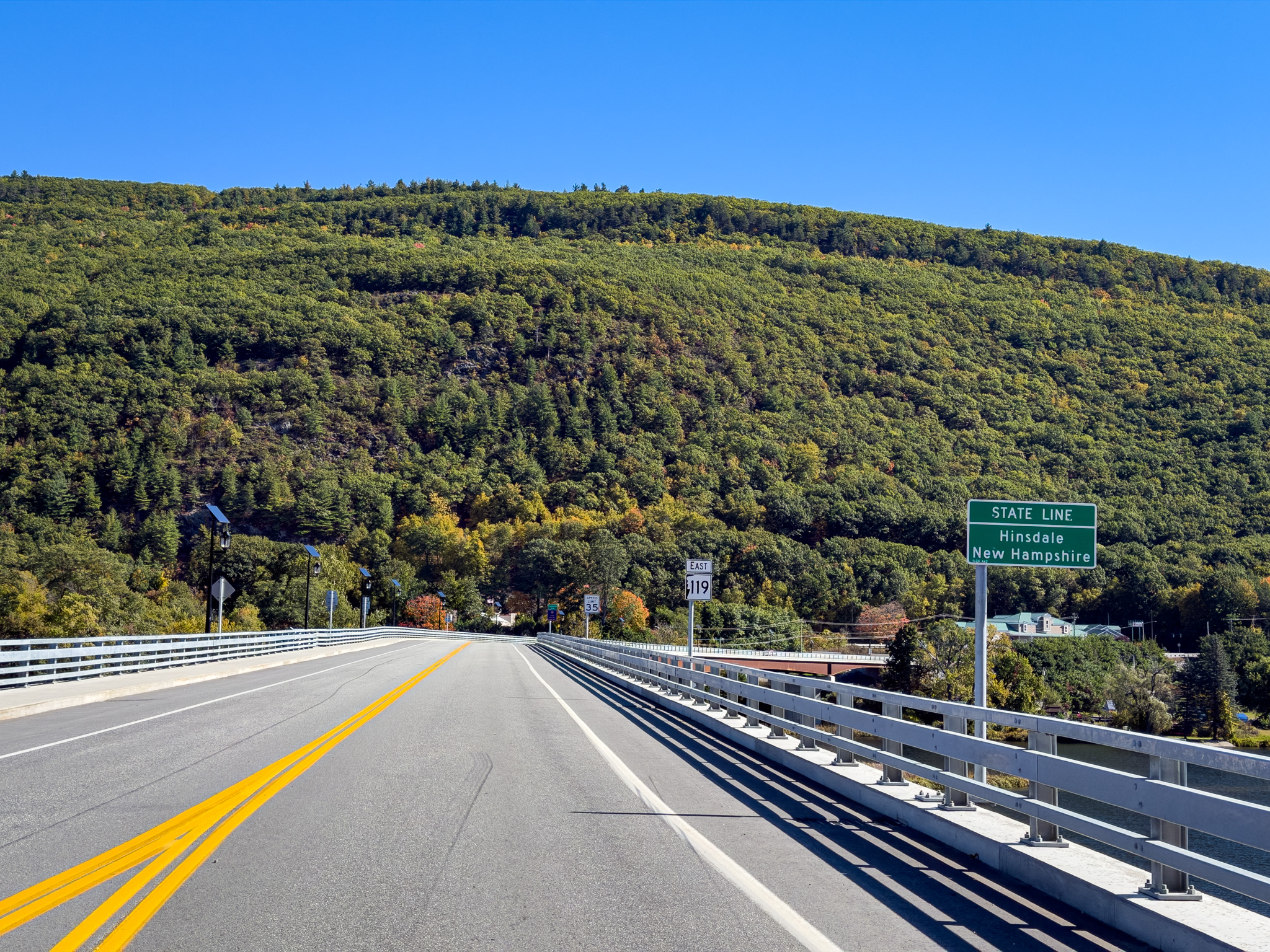 Bridge into New Hampshire with a state line sign