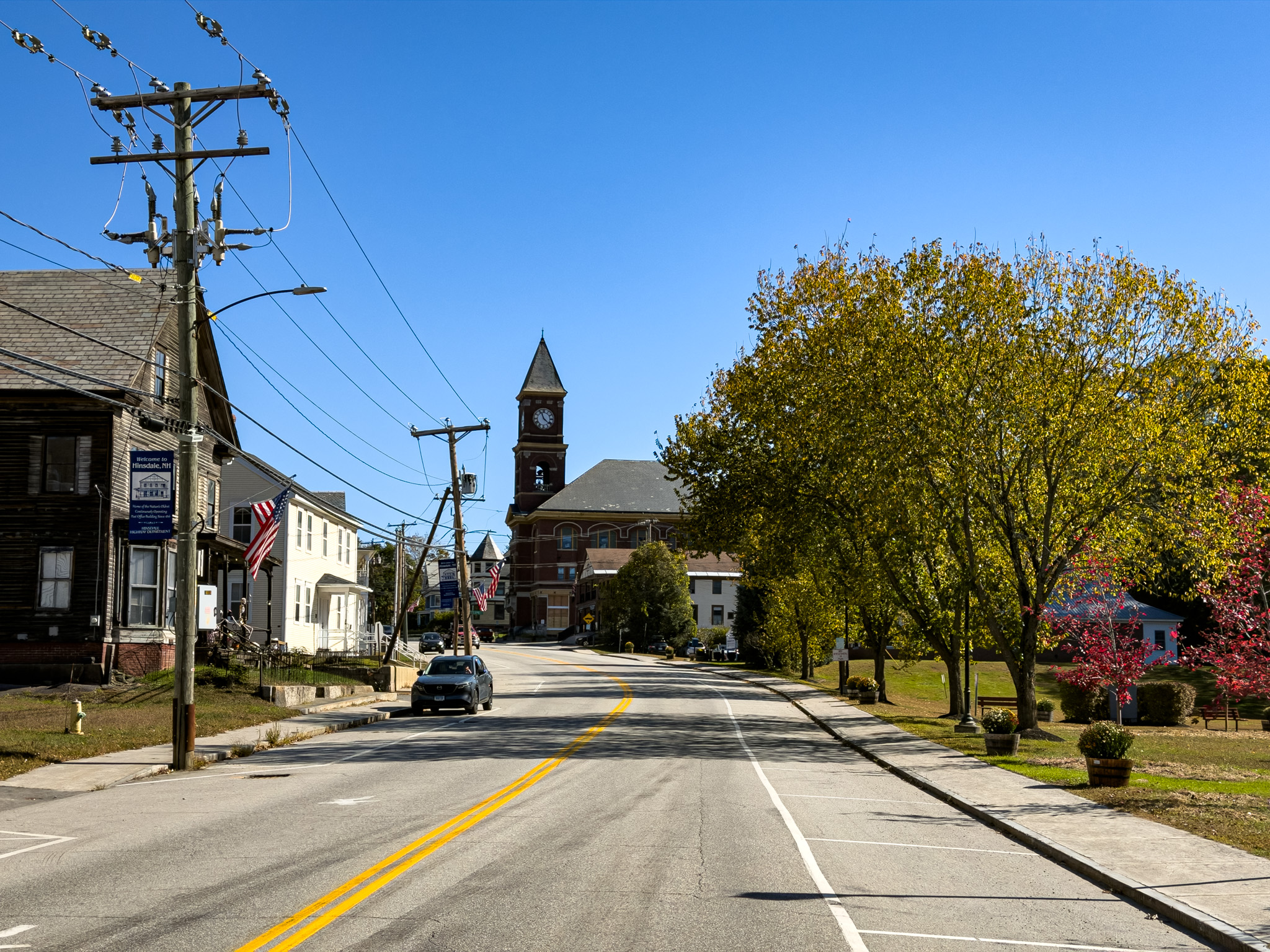 Brick building with a clock tower on a quiet New England street