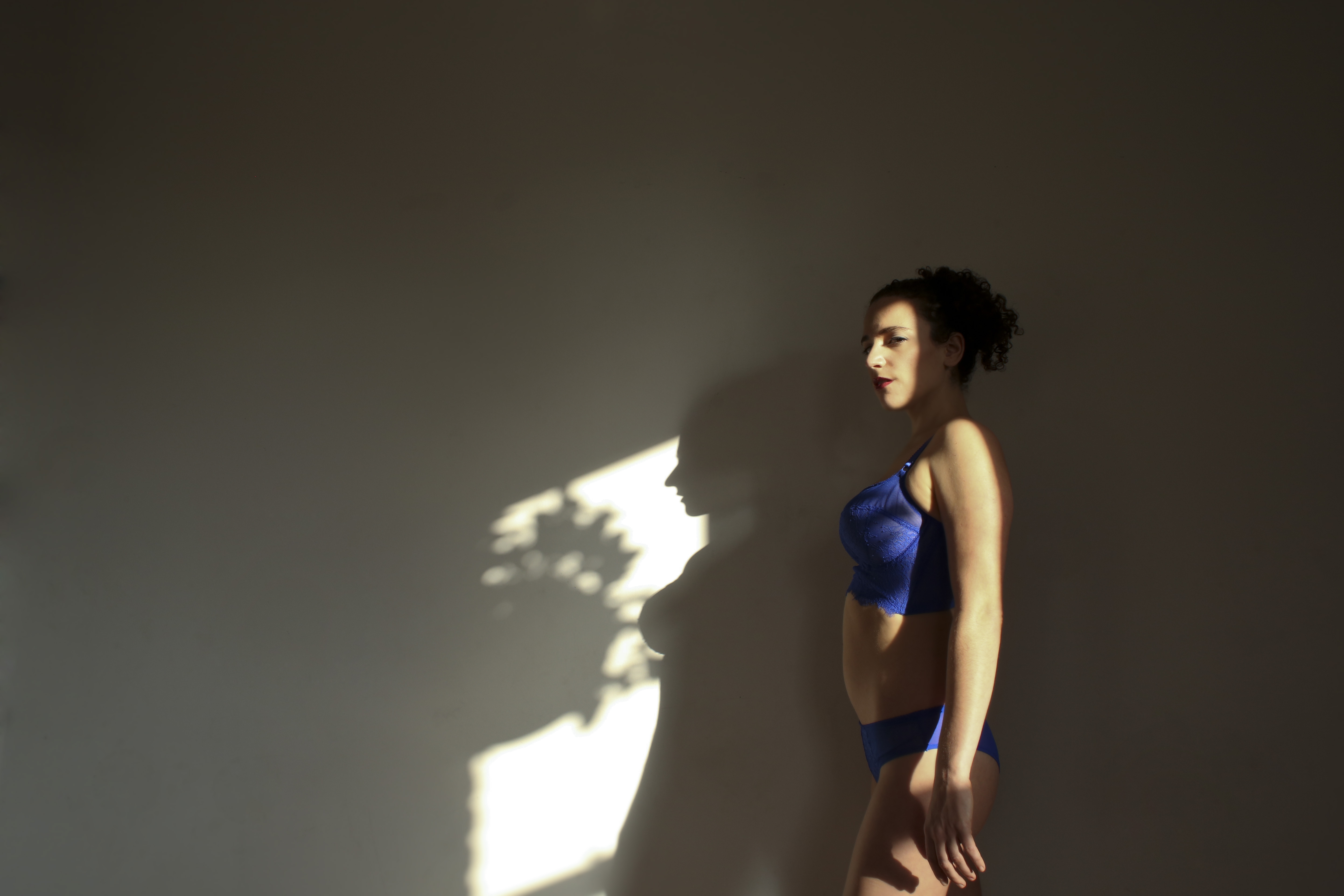 Mistress Blunt instructor of kinky bdsm yoga plays in the shadows