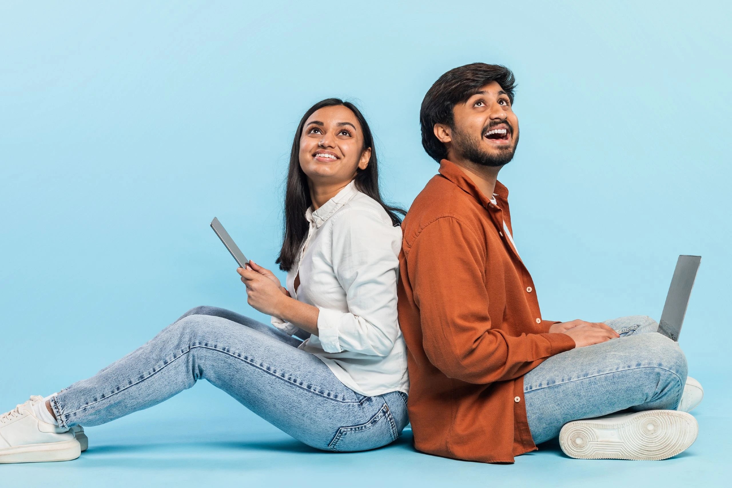two people happy to get laptops on loan as device lock technology enabled lenders
