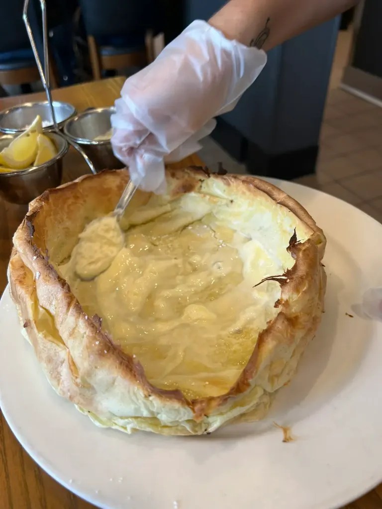Cheese fondue served in a hollowed-out bread bowl, ready for dipping.