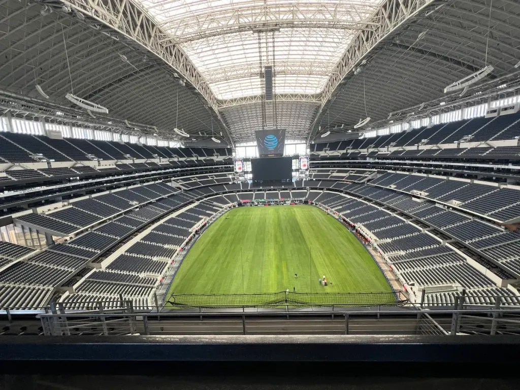 Dallas Stadium with bright green field below and skylight above