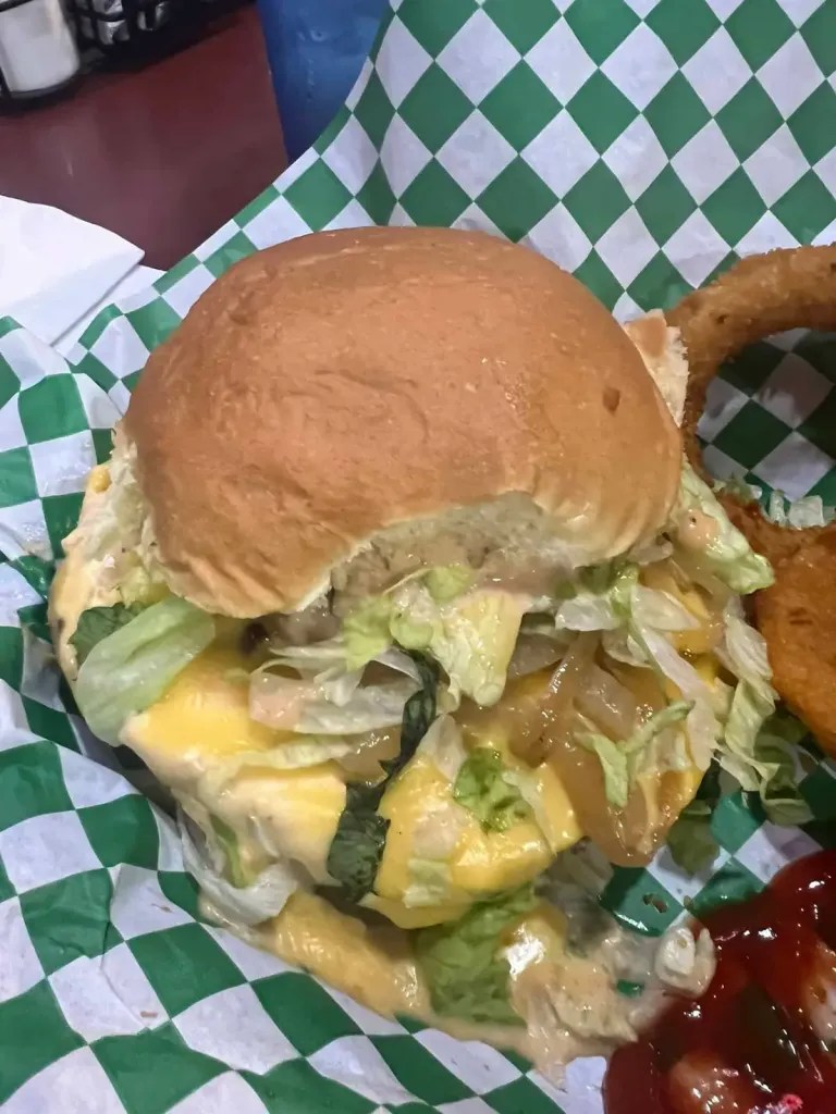 Delicious cheeseburger with lettuce, onions, and special sauce - known as a Juicy Lucy