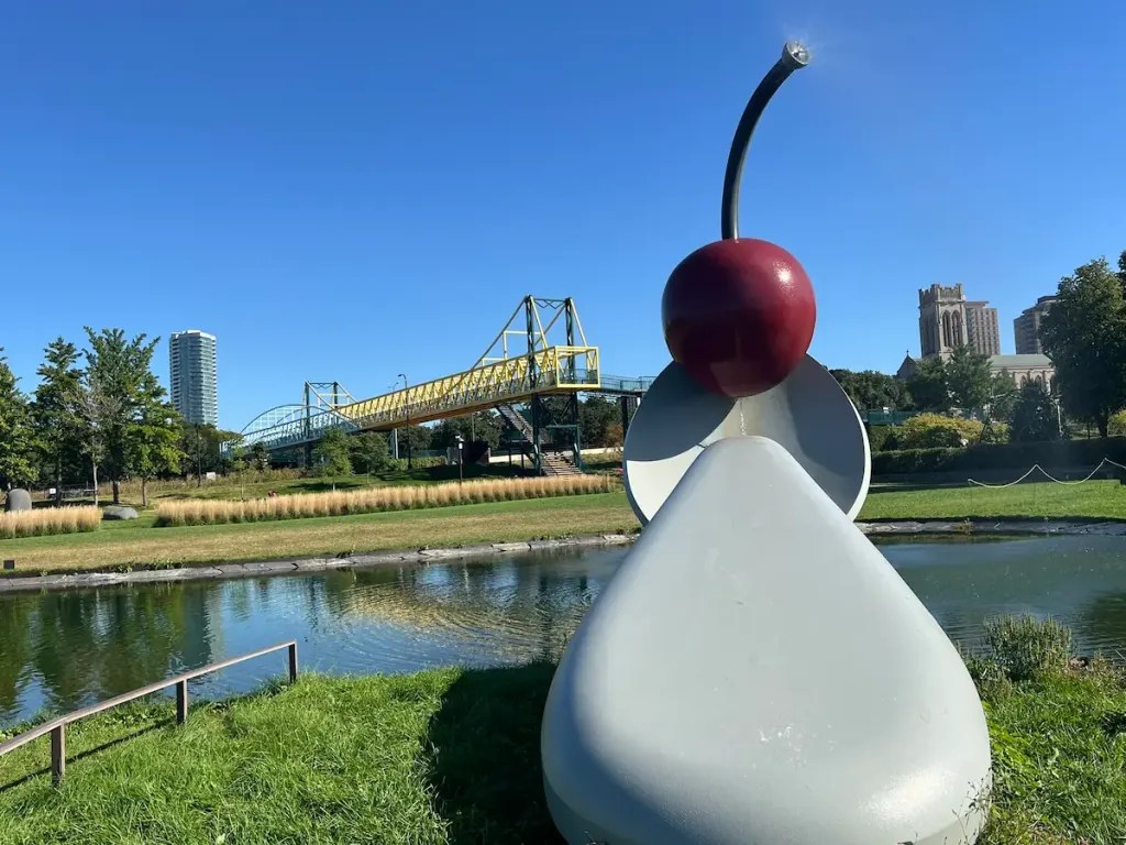 The Spoonbridge and Cherry sculpture at the Minneapolis Sculpture Garden, with the city skyline behind