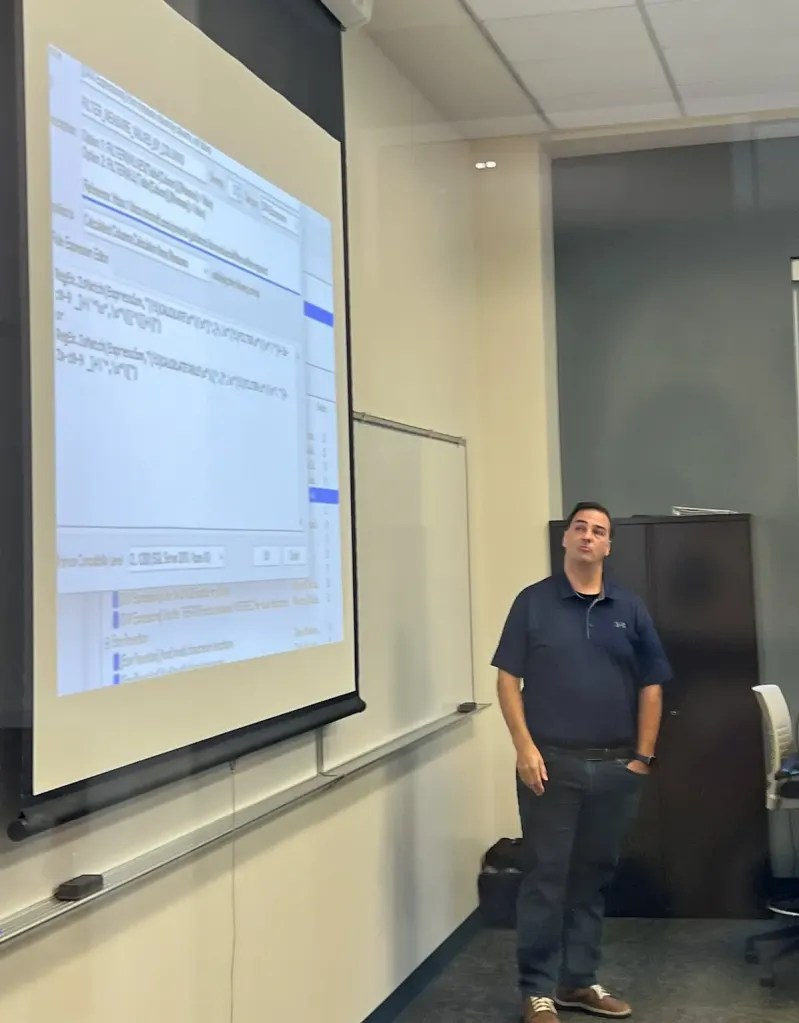 Jason Romans presenting at showing a slide with Tabular Editor Best Practice Analyzer on screen