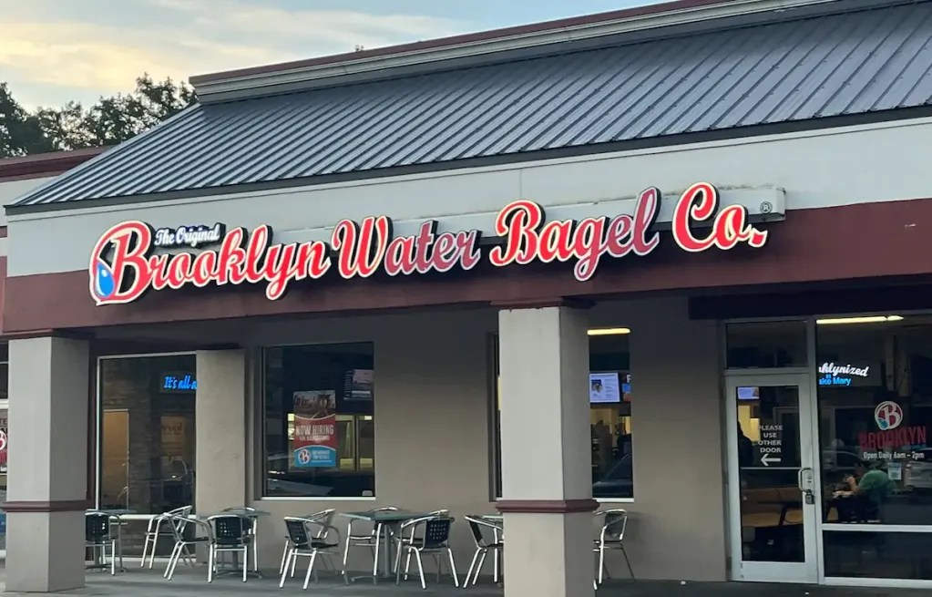 Brooklyn Water Bagel Co storefront with outdoor seating and signage.