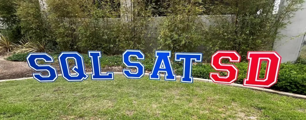 SQL SAT SD in the grass in front of the building