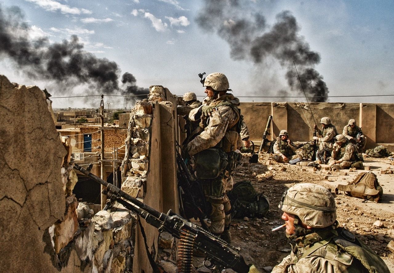 Soldiers stand guard on bombed out rooftop during Battle of Fallujah