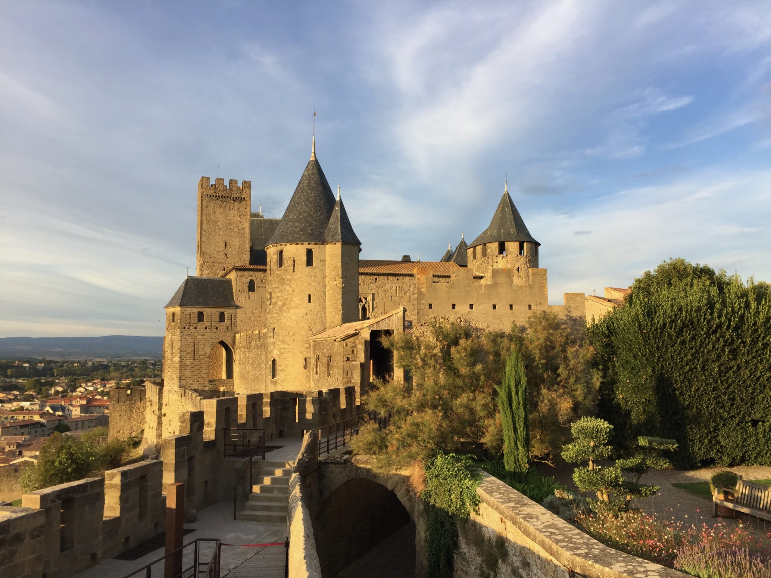 Historic stone castle with towers under a blue sky.