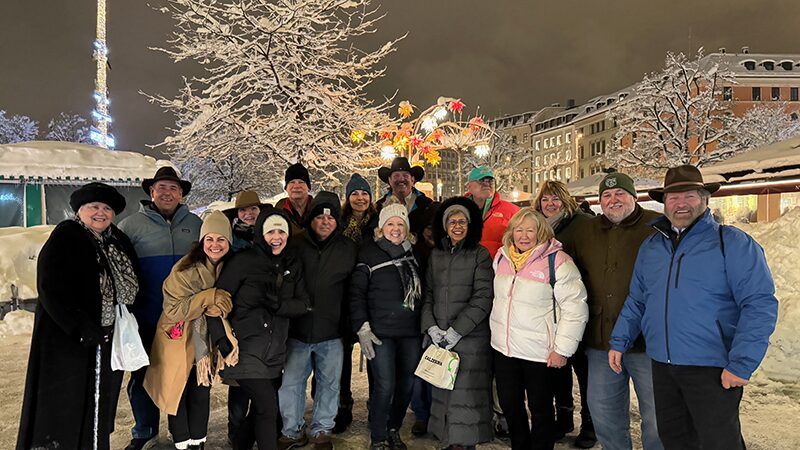 Group of friends enjoying a festive winter evening outdoors.