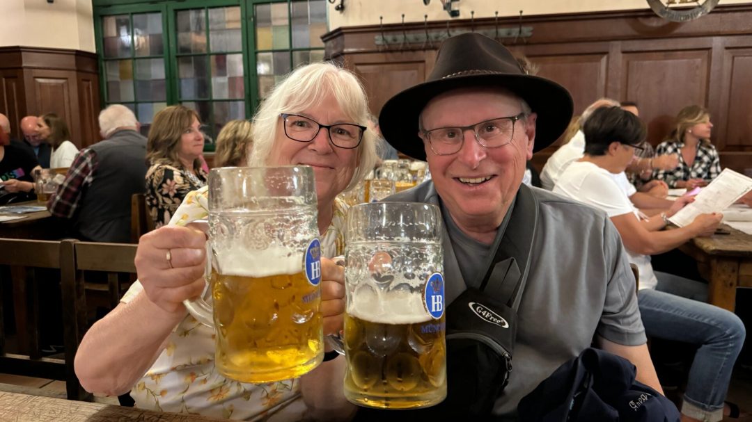A couple toasting beer steins in Munich