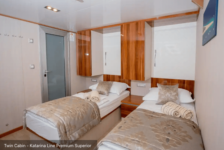 Cozy twin stateroom with folded towels