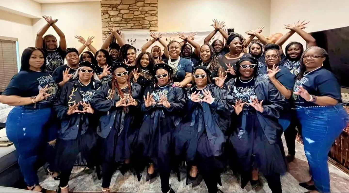 Members of Psi Sigma Upsilon Sorority, Inc. posing together in coordinated attire and signature hand signs during a sisterhood gathering.