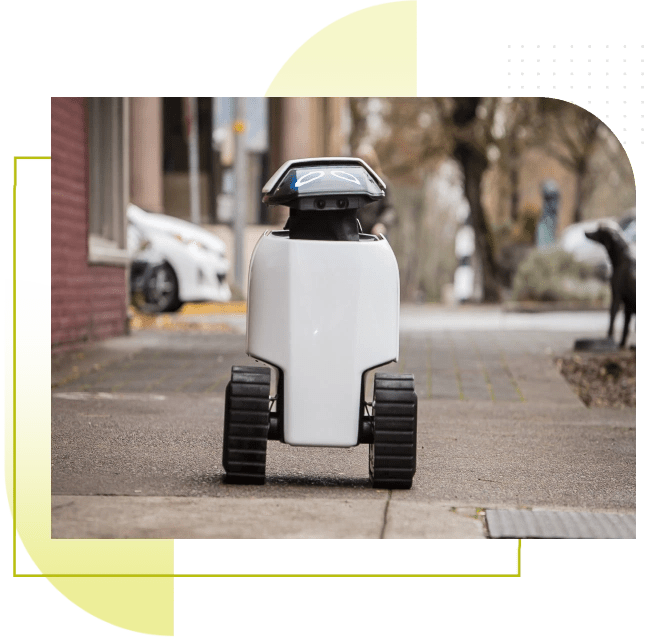 Dax robot rolling down a sidewalk in a city