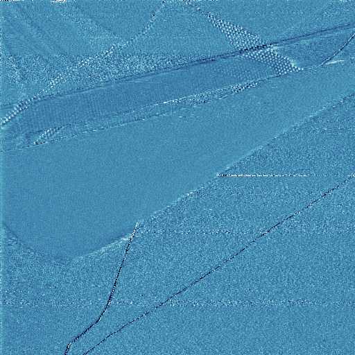 HOPG surface after cleaving, showing what appears to be a moiré pattern at the top right. Those small bumps are too large to be atoms. Tunneling current image acquired in constant current mode.