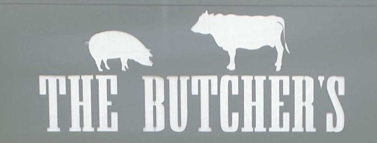 The sign for a butcher shop, with an incorrectly used apostrophe—an English copywriting agency wouldn't have made this mistake