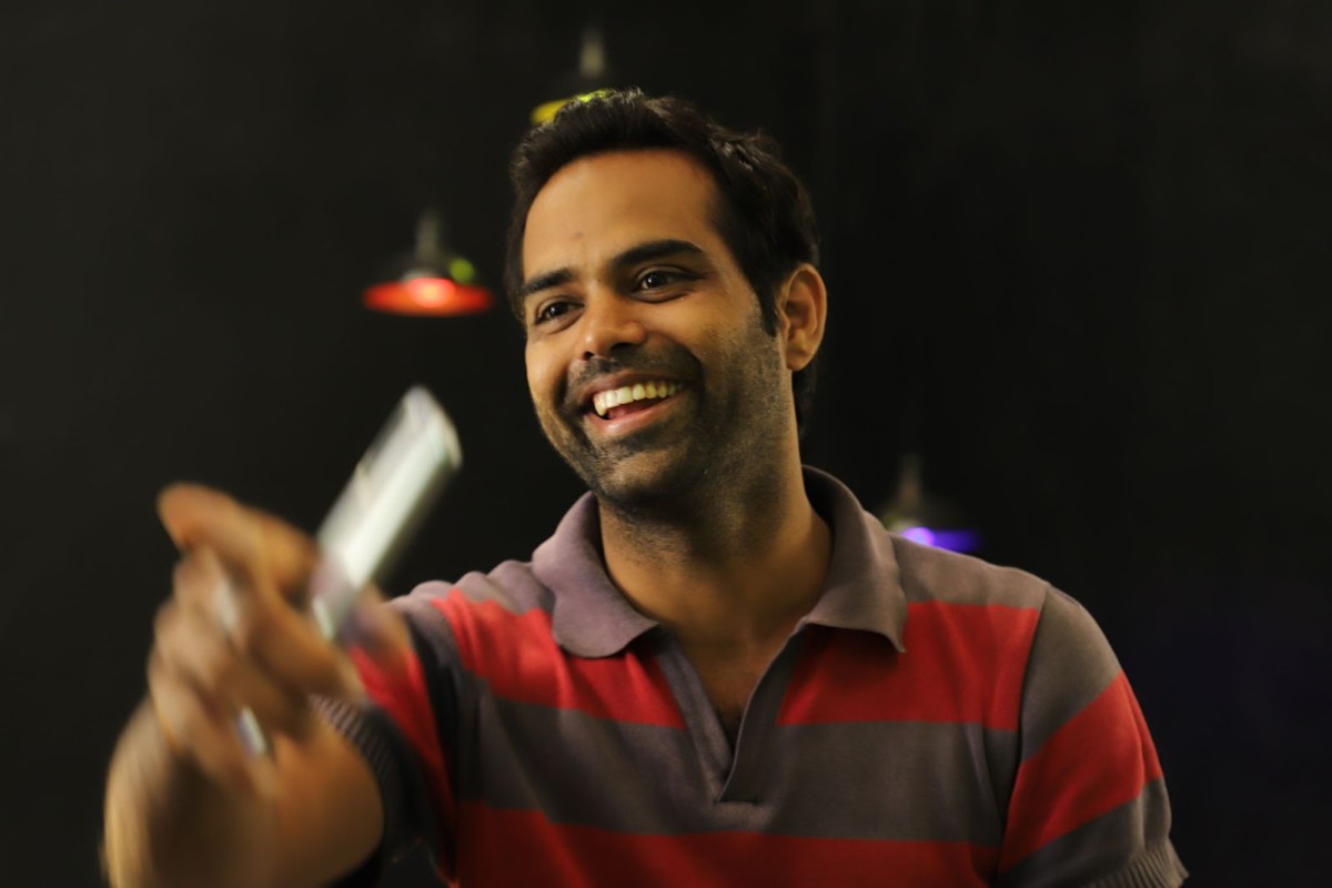 A photo of a smiling man, pointing as if to say, "I got you!"
