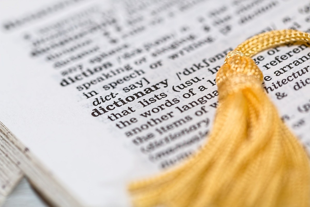 A close up shot of an entry for the word 'dictionary' in a dictionary. 