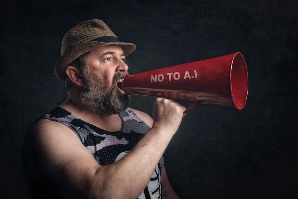 A man shouting into an old-school megaphone with "Not to AI" written on the side