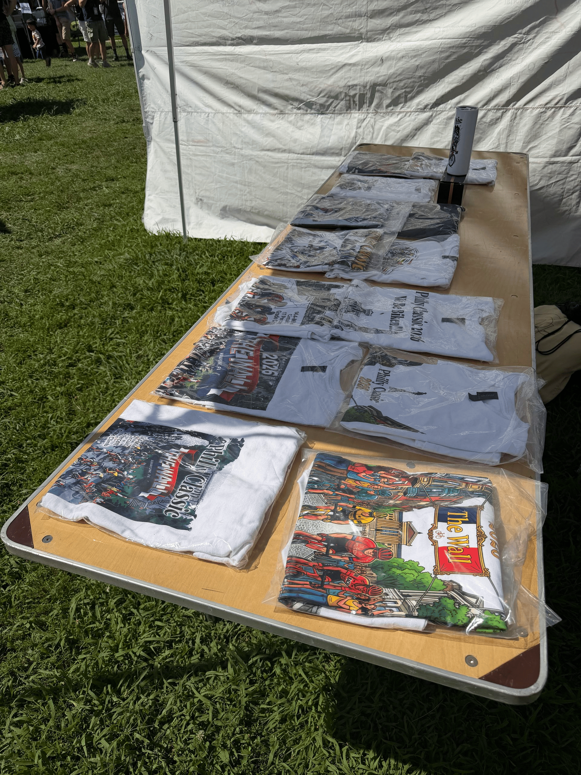 Custom merchandise table setup with DTF prints and apparel hoodies | D-Day Entertainment Philadelphia