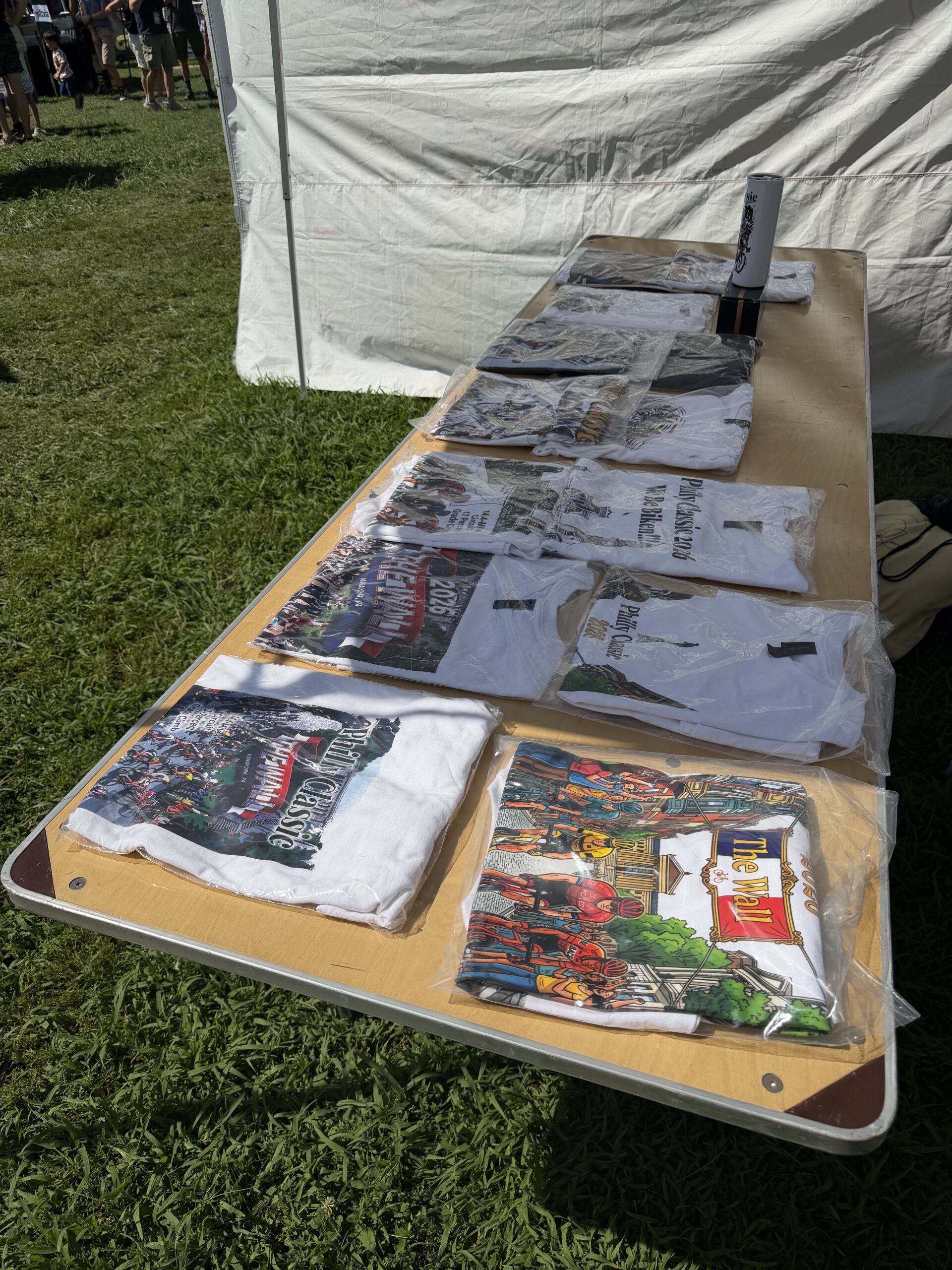 Custom merchandise table setup with DTF prints and apparel hoodies | D-Day Entertainment Philadelphia