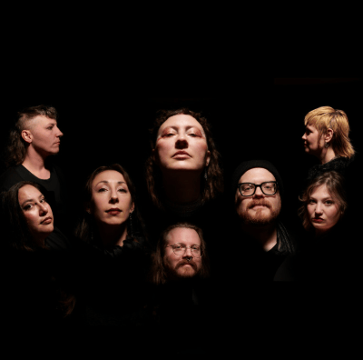 Picture of a black background with 8 different light skinned people in various facial poses/expressions