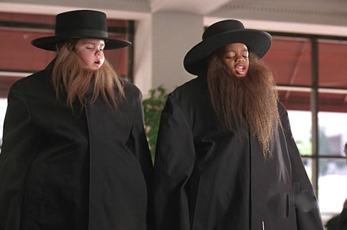 Movie still from Little Rascals; two boys in disguise wearing hats, beards, and trench coats